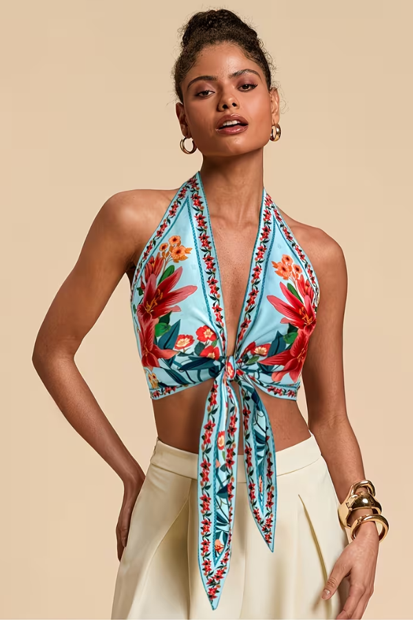 Women's vacation outfit: a vibrant floral print halter top for ultimate summer comfort.