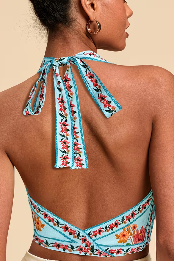 Get ready for summer with this vibrant floral halter top for women, a stylish sleeveless piece.