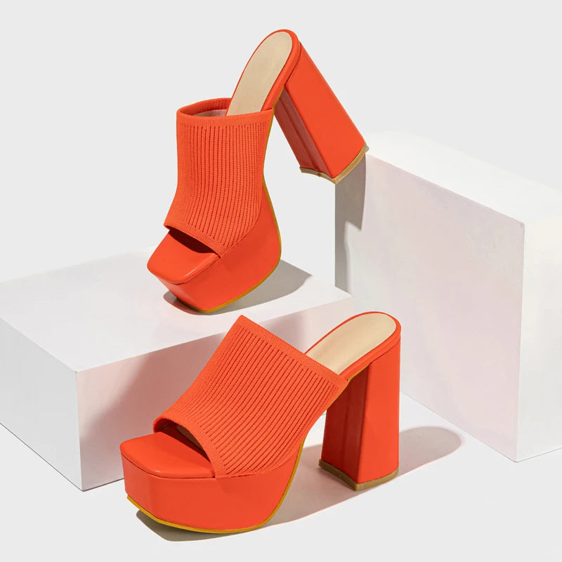 Orange neon platform block high heels. Vibrant women's Y2K party shoes, a chunky retro statement.