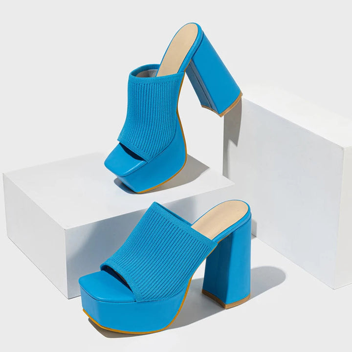 Vibrant neon platform block heels for women. Chunky Y2K party shoes, a retro slip-on design.