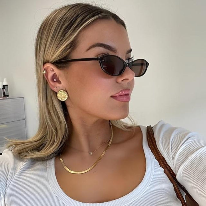 Distinctive women's leopard print 90s cat-eye sunglasses, retro vintage accessory with UV400 eye protection.