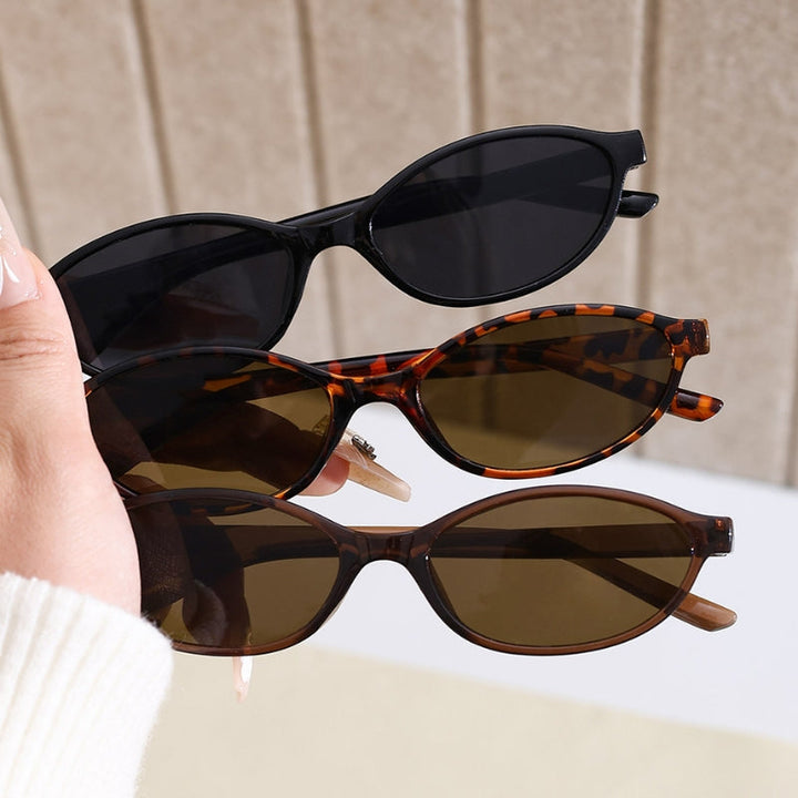 Black women's 90s cat-eye sunglasses, vintage retro style fashion accessory providing UV400 eye protection.