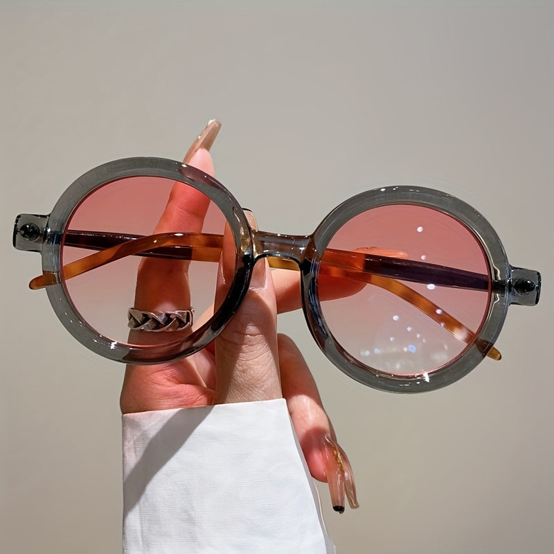 Elegant women's circular sunglasses, blending vintage style with modern UV400 eyewear tech.