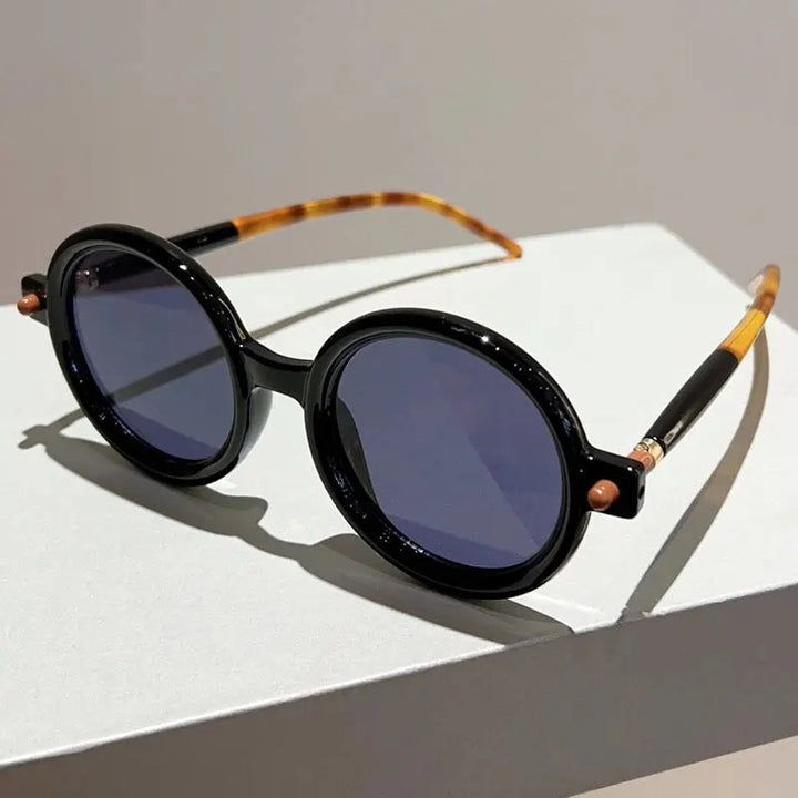 Side view: women's retro round sunglasses, highlighting the sleek frame and UV400 lenses.