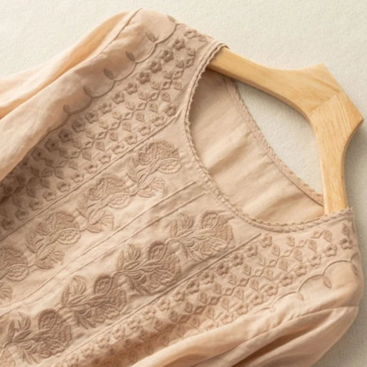 Chic women's vintage blouse featuring delicate embroidery and stylish sheer puff sleeves. Summer fashion essential.