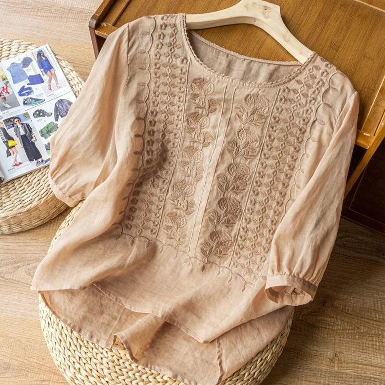 Elegant embroidered women's top with romantic sheer three-quarter puff sleeves and round neck. Vintage style.