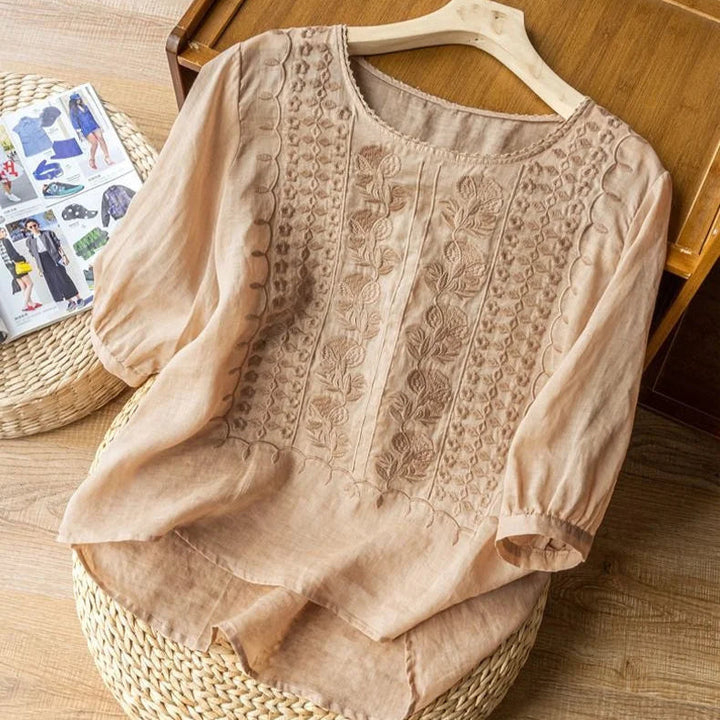 Elegant embroidered women's top with romantic sheer three-quarter puff sleeves and round neck. Vintage style.