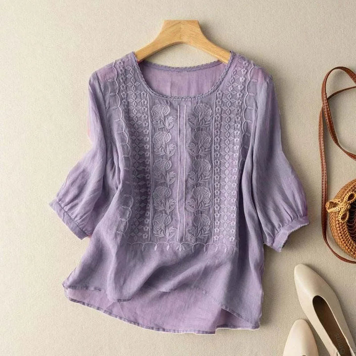 Classic women's vintage embroidered top with sheer puff sleeves. Round neck and three-quarter length.