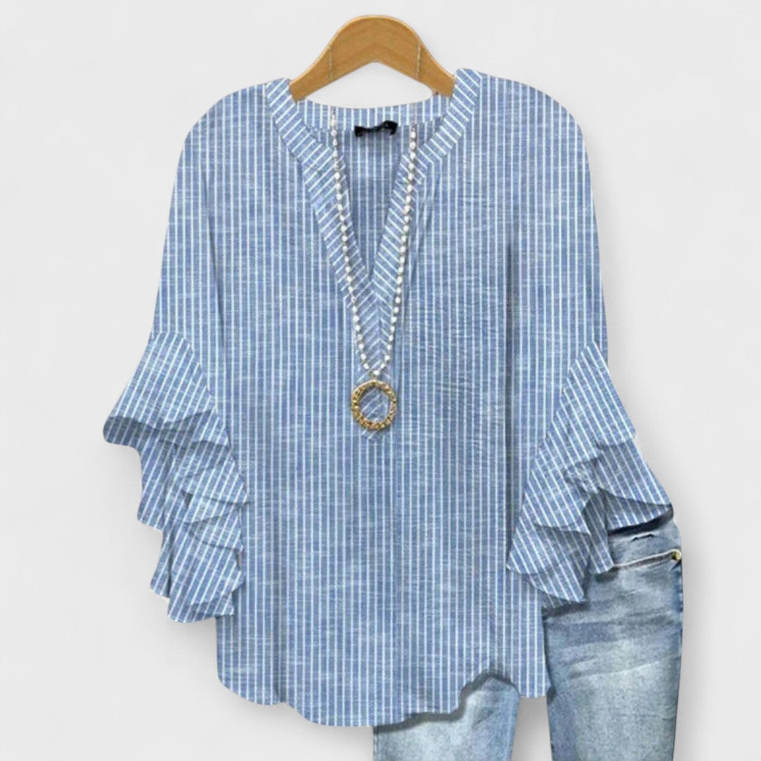Feminine vintage-style floral blouse for women, with a flattering V-neck and pretty ruffle sleeves.