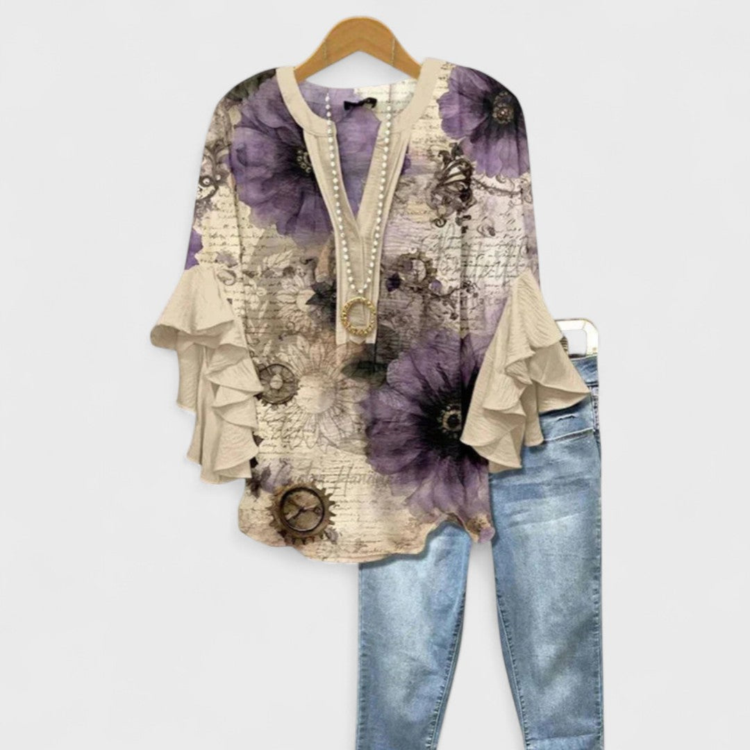 Delicate floral print women's blouse with V-neckline and charming ruffle sleeves, feminine spring wear.