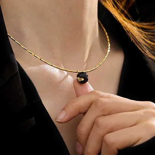 Close-up of a unique vintage gold crackle statement necklace, showcasing its intricate details.