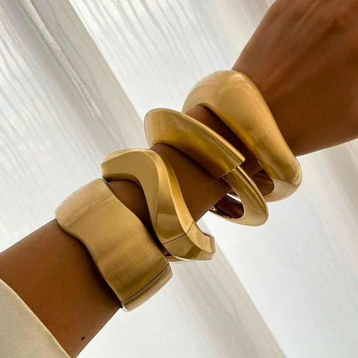 Fashionable women's vintage gold cuff bracelet set with a unique brushed finish and organic design.