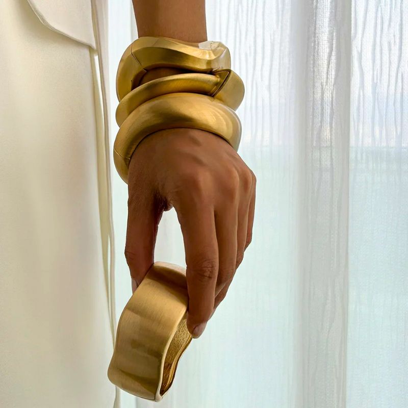Stunning vintage gold cuff bracelet set for women, showcasing brushed metal and an organic jewelry design.