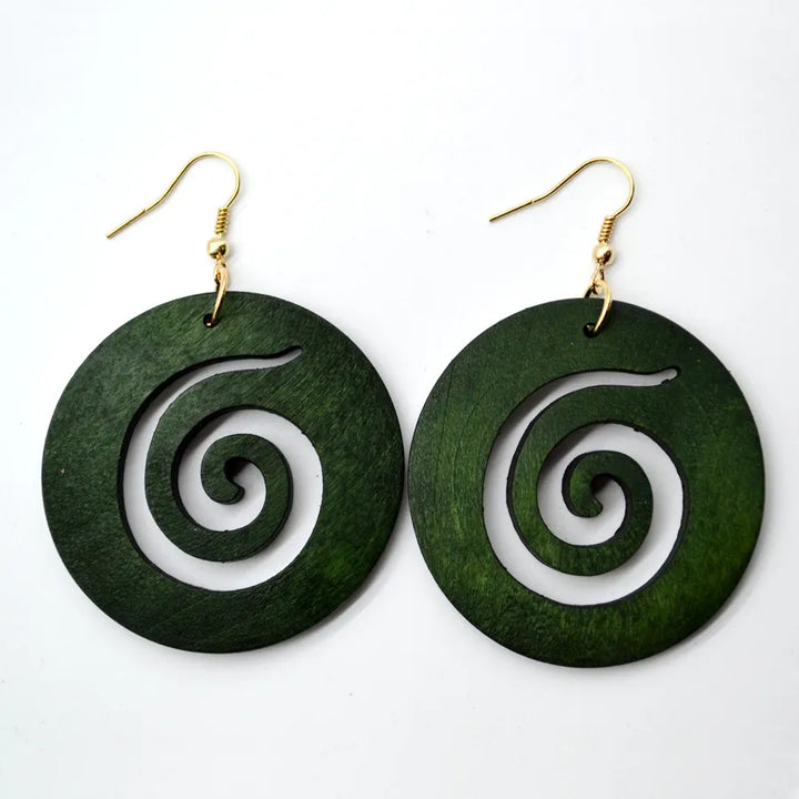 Boho-chic green carved wood earrings; handmade vintage style dangle jewelry, a unique fashion statement.