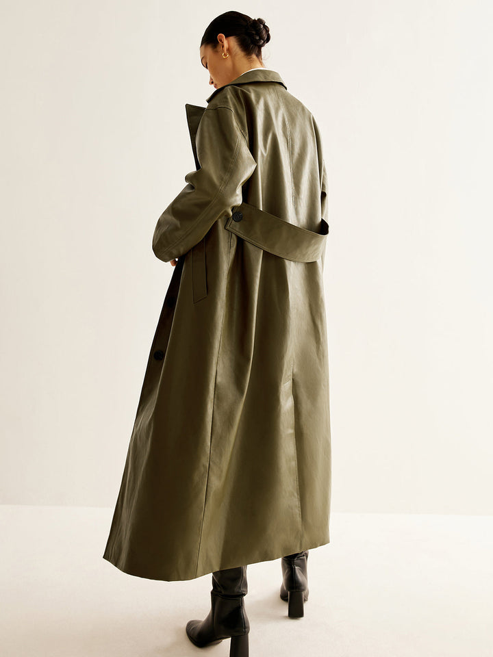 Women's vintage green leather longline jacket. Chic oversized fit, perfect for stylish outerwear.