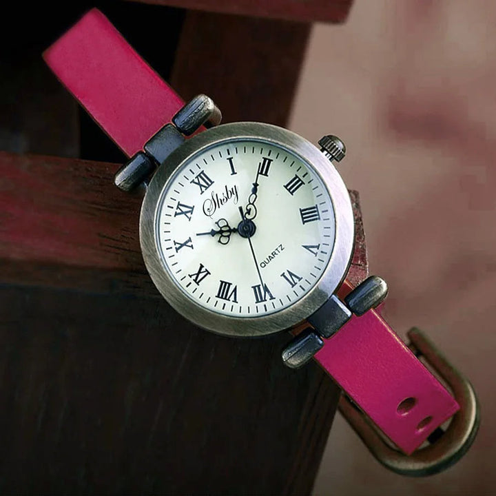 Delicate women's vintage timepiece with an elegant leather strap and clear quartz display.