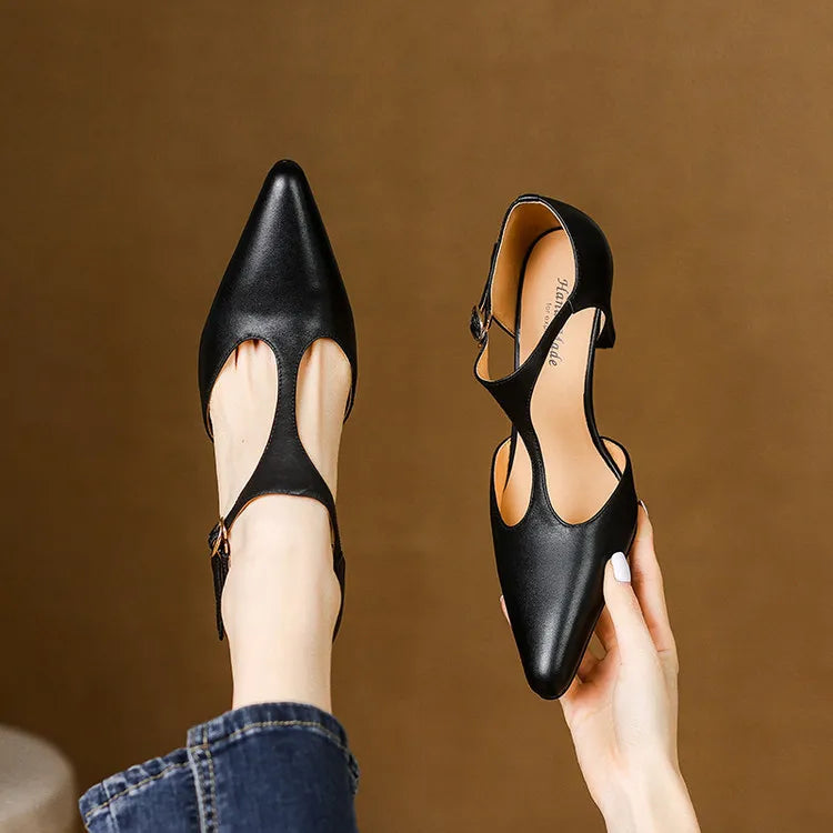 Polished black women's vintage T-strap heels, offering a sophisticated and comfortable dress shoe option.