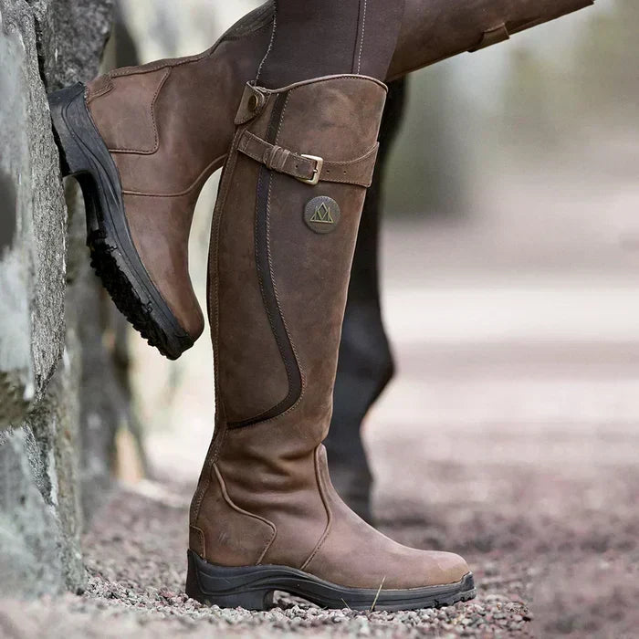 Women's vintage knee-high Luna boots. Elegant brown leather, perfect for fall fashion & timeless style.