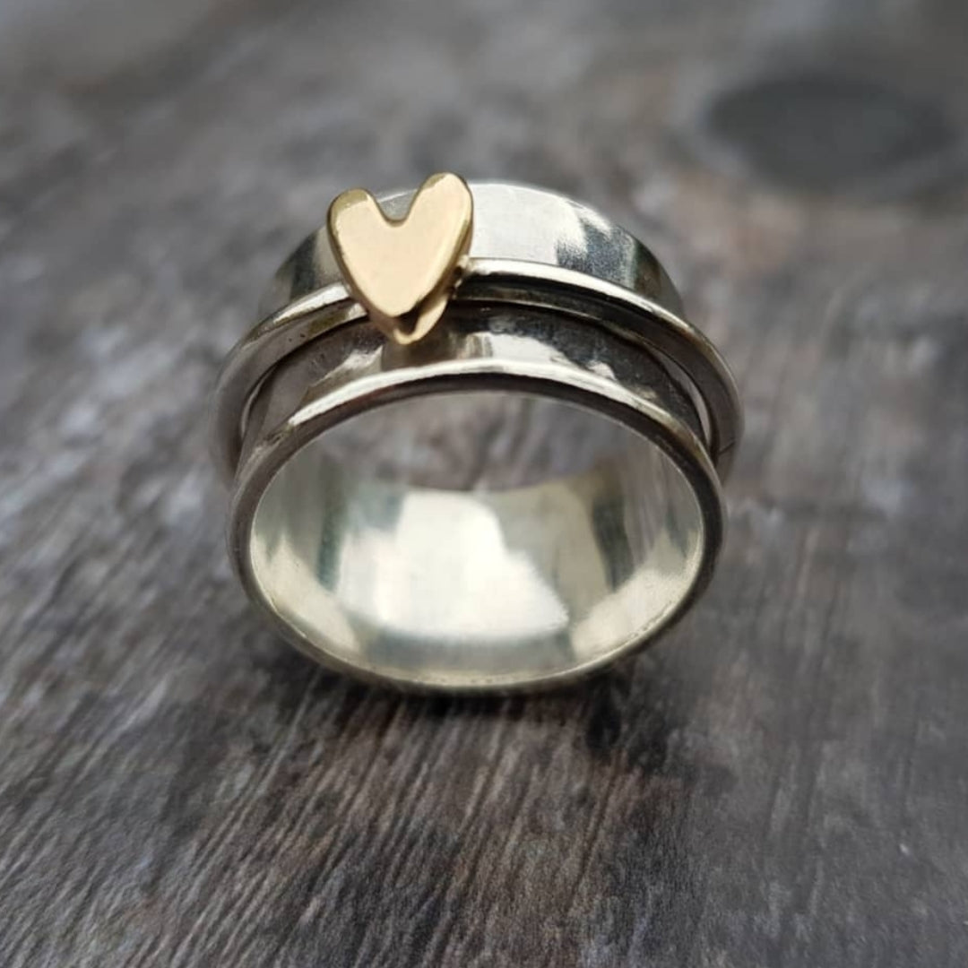 Women's vintage silver ring with golden heart detail, elegant two-tone fashion jewelry for her.