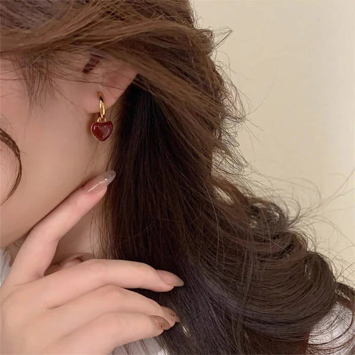Detailed gold plated vintage split heart drop earrings. Women's fashion and romantic heart jewelry accessory.