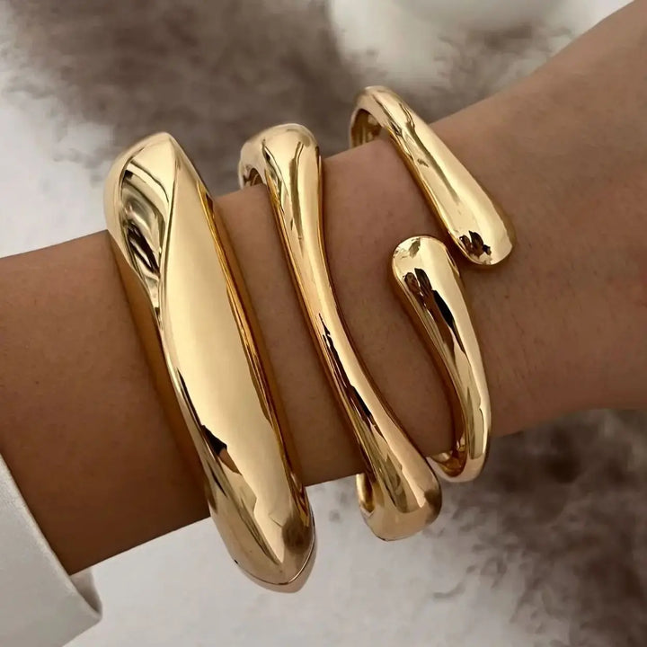 Close-up of a women's vintage stackable bracelet set in gold & silver tones, stylish jewelry.