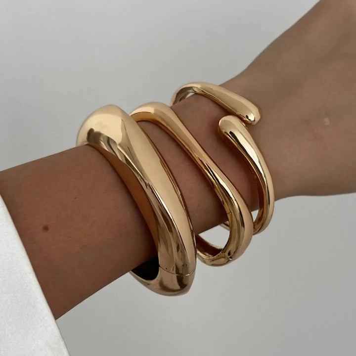 Set of elegant women's vintage stackable bracelets, gold & silver finish, a classic fashion jewelry accessory.