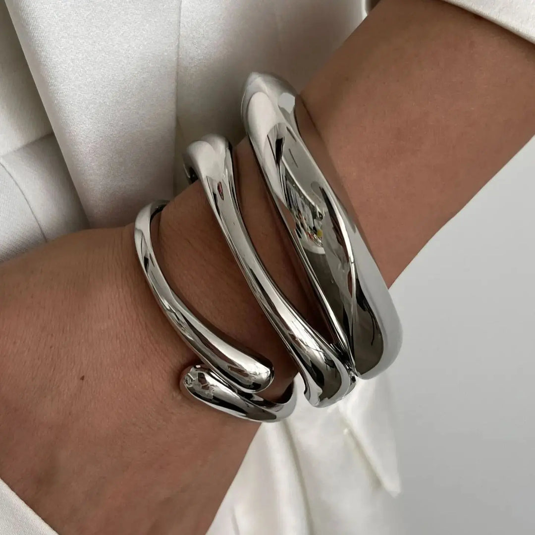Women's vintage stackable bracelet set, featuring intricate gold & silver designs, a timeless jewelry piece.