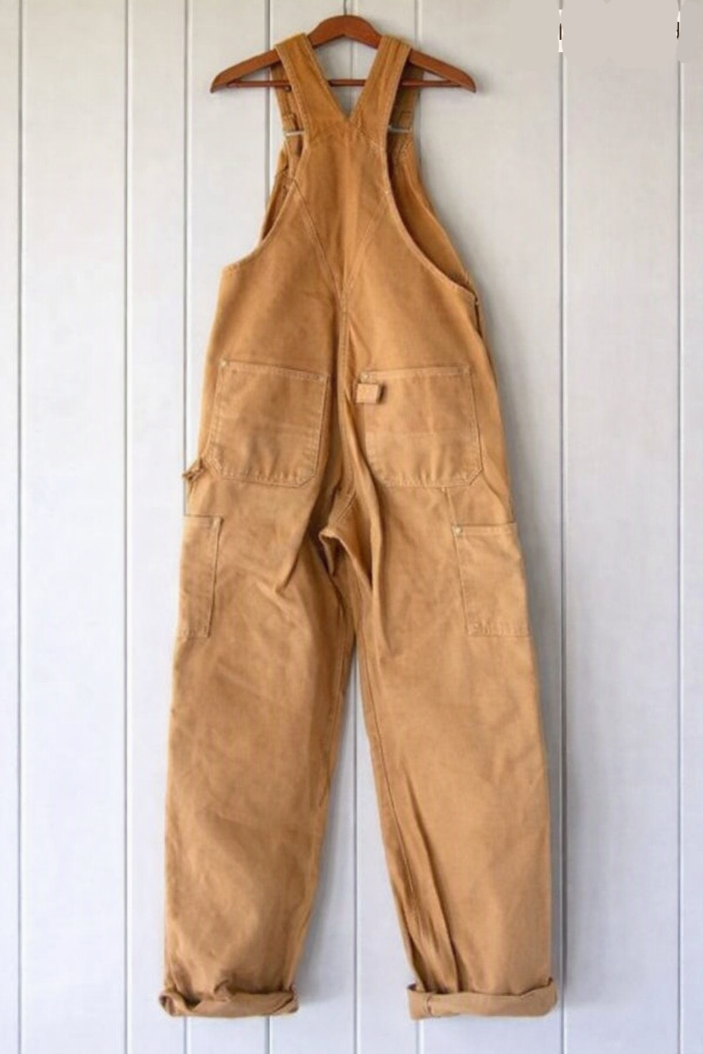 Relaxed fit women's vintage-style overalls with adjustable shoulder straps and utility pockets.