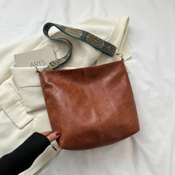 Close-up of a women's classic vintage shoulder bag. Stylish retro handbag, an essential everyday fashion accessory.