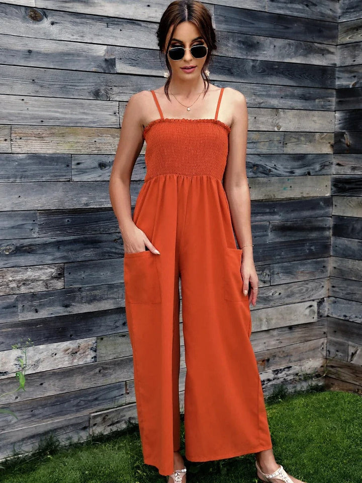 Close-up of a women's vintage print jumpsuit, showing spaghetti straps and fabric texture