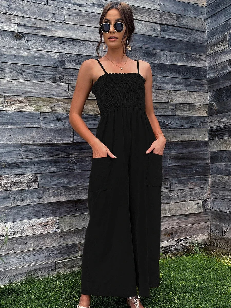 Full shot of a model wearing a women's vintage spaghetti strap jumpsuit with wide legs