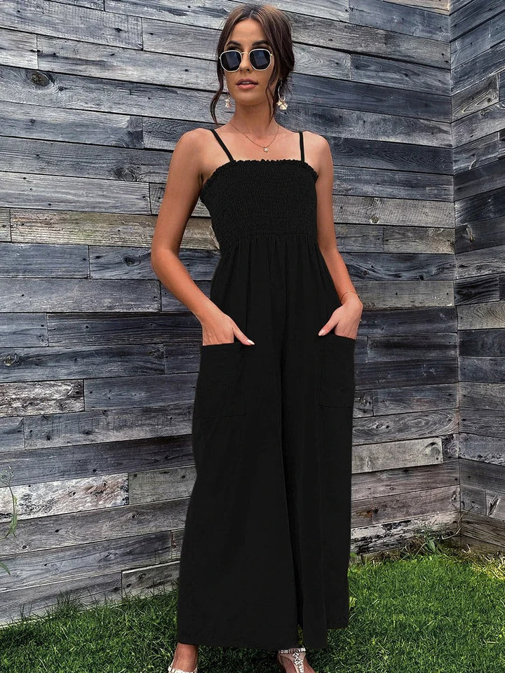 Full shot of a model wearing a women's vintage spaghetti strap jumpsuit with wide legs