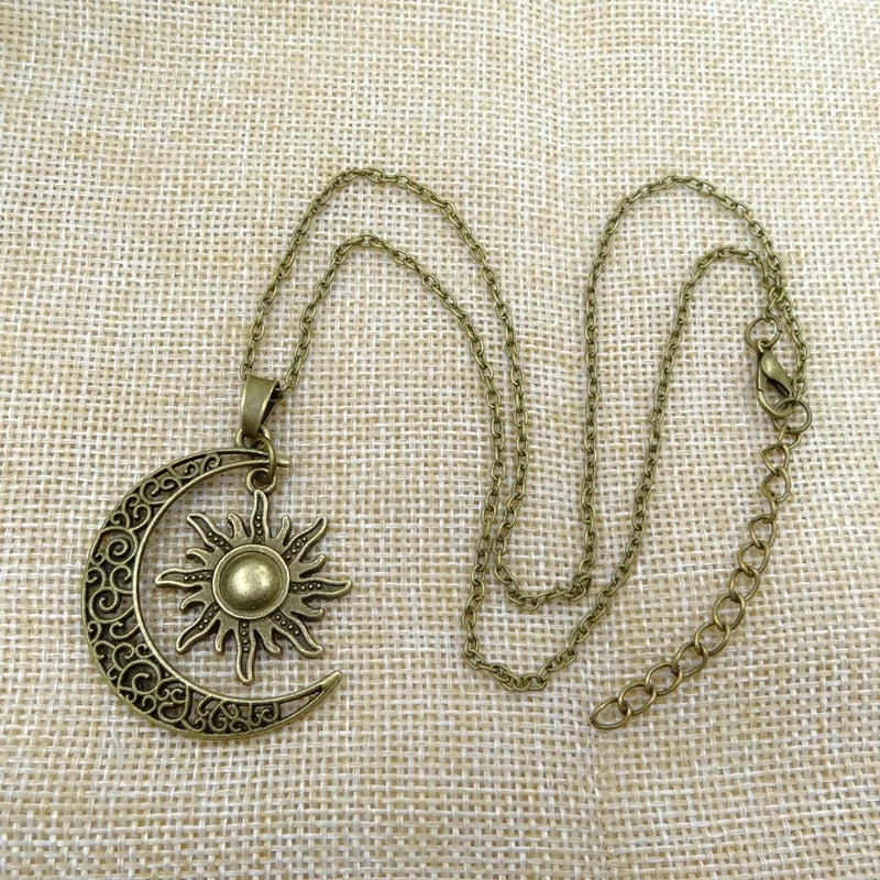 Close-up of a women's vintage sun and moon necklace, intricately designed celestial pendant, perfect statement jewelry.