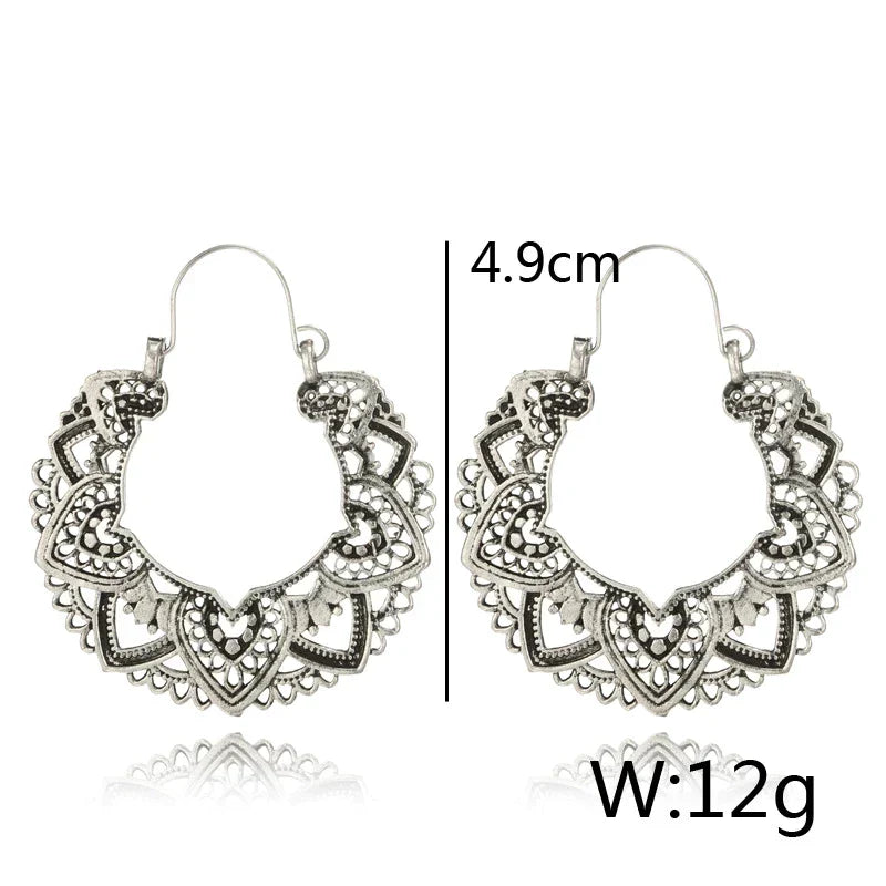 Fashionable women's vintage totem drop earrings. Unique gold & silver design, an elegant statement accessory.