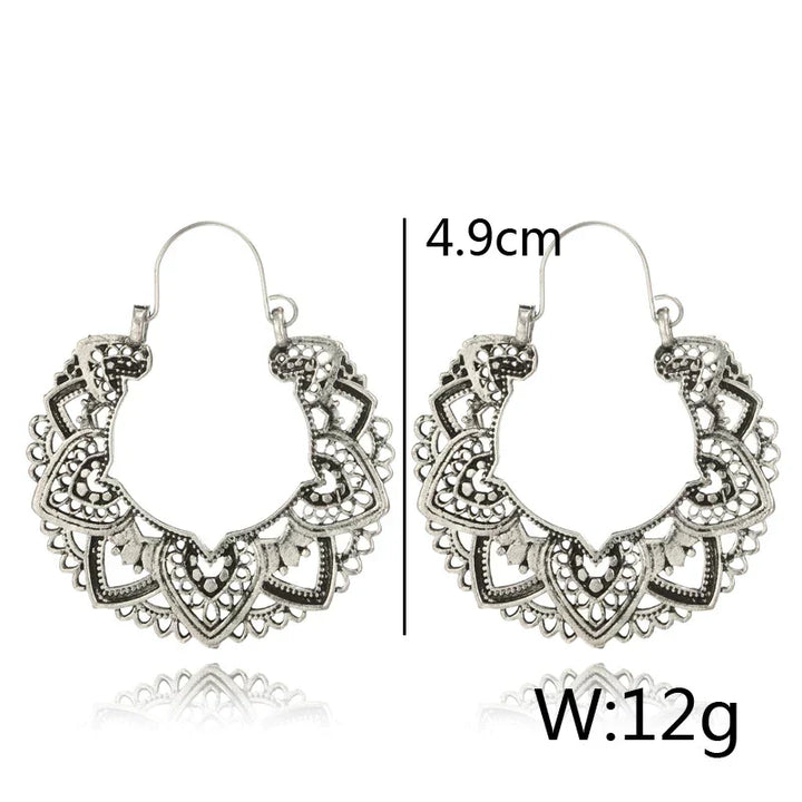 Fashionable women's vintage totem drop earrings. Unique gold & silver design, an elegant statement accessory.
