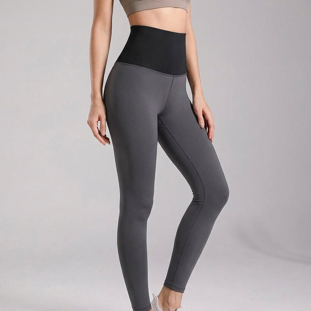 Athletic woman performing a yoga pose wearing Vivian high-waisted sports leggings, showing flexibility