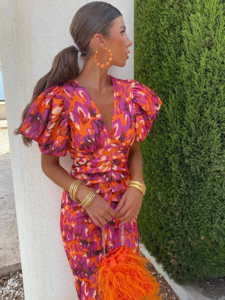 Flattering vibrant ruched midi dress for women, featuring chic sculpted shoulders. Ideal for evening wear.