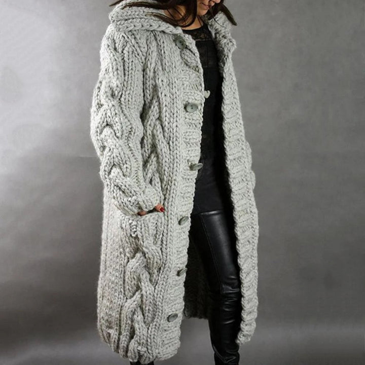 Cozy hooded maxi cardigan for women, featuring a beautiful cable knit pattern. Ideal warm outerwear for winter.