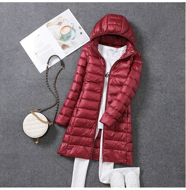 Women's warm hooded puffer coat for ultimate winter comfort & cold weather protection. Stylish & cozy long jacket.