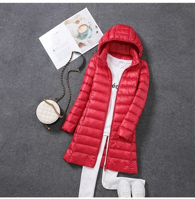 Fashionable women's long hooded puffer jacket. Ideal winter outerwear, keeping you warm and cozy in cold weather.