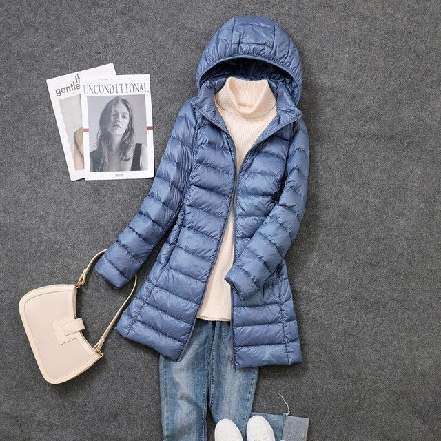 Women's hooded puffer coat, new for winter. Provides warm, comfortable protection against cold. A long, cozy jacket.