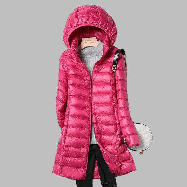 New women's warm hooded puffer coat. Long winter outerwear designed for cozy comfort in cold weather conditions.