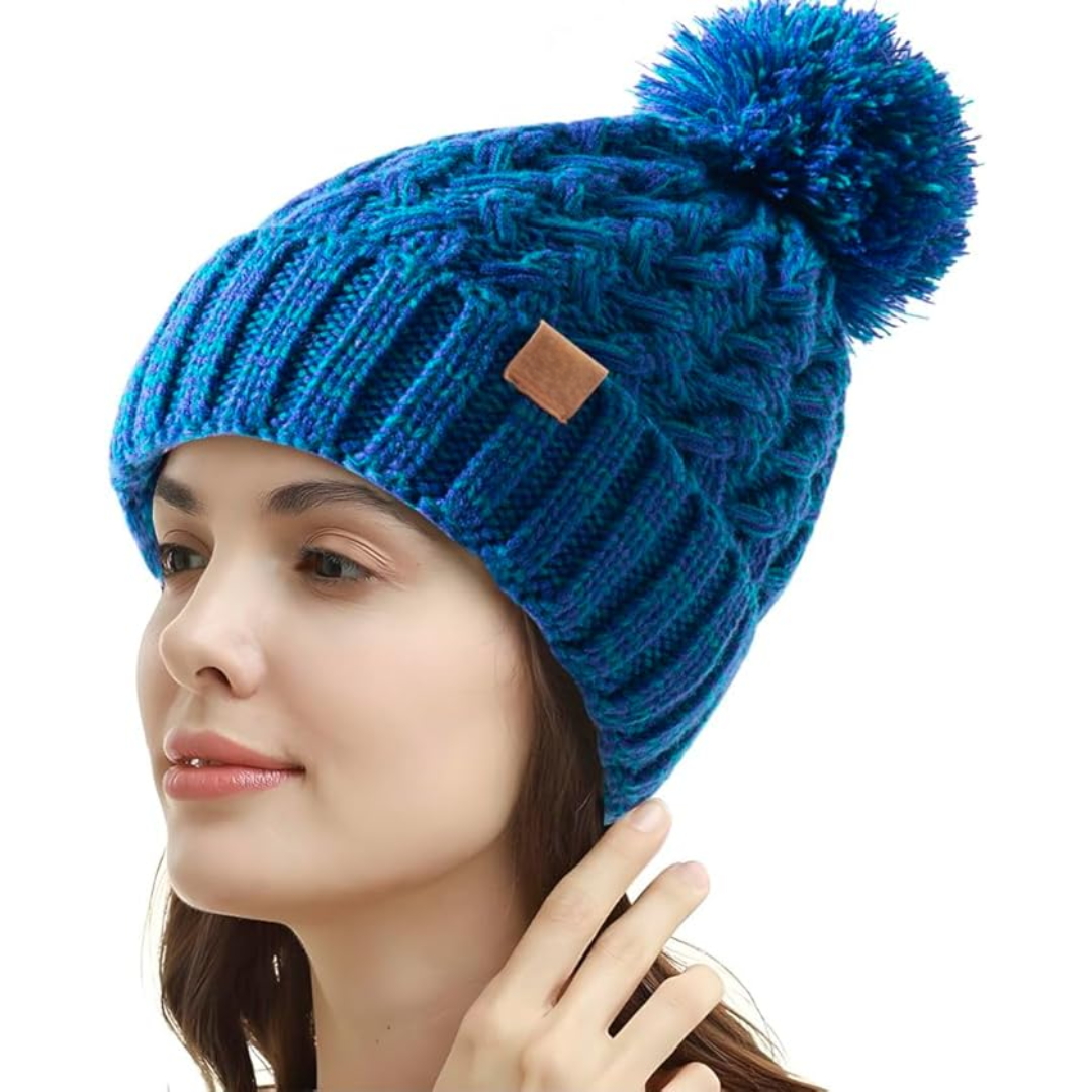 Warm Yvonne women's beanie with a large, fluffy pom, suitable for various winter activities.