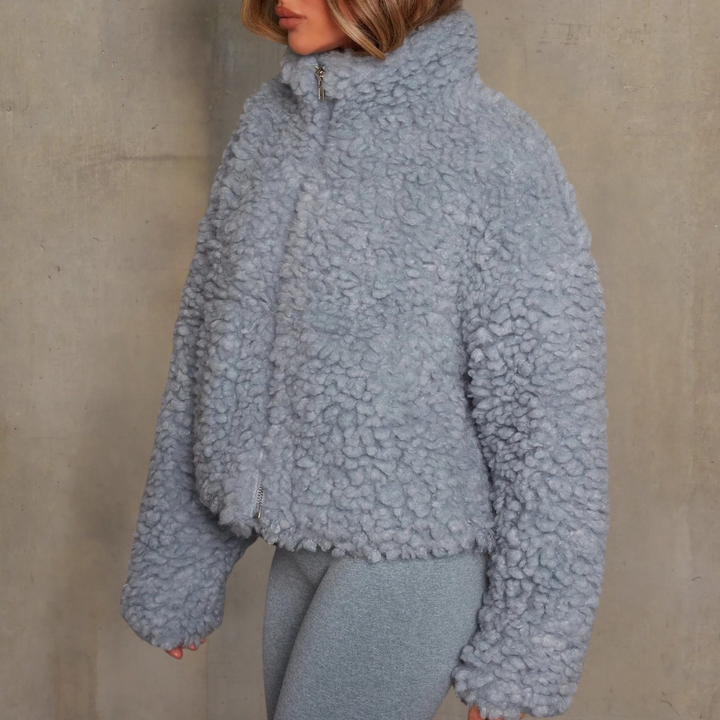 Elegant women's warm winter coat with a soft velvety feel. Long-sleeve outerwear, ideal for cold weather comfort.