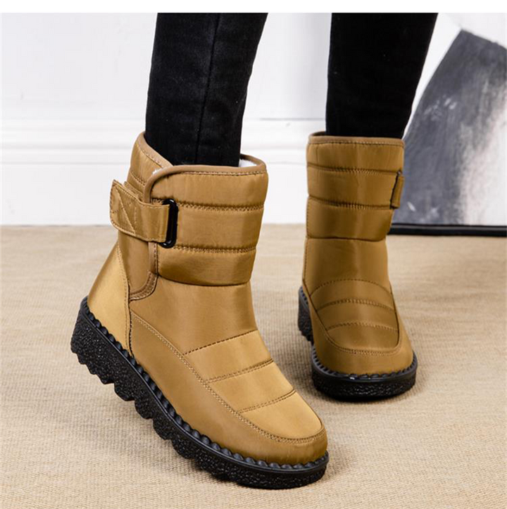 Chic women's waterproof winter boots with secure lacing & warm padding, perfect for fashion & function.