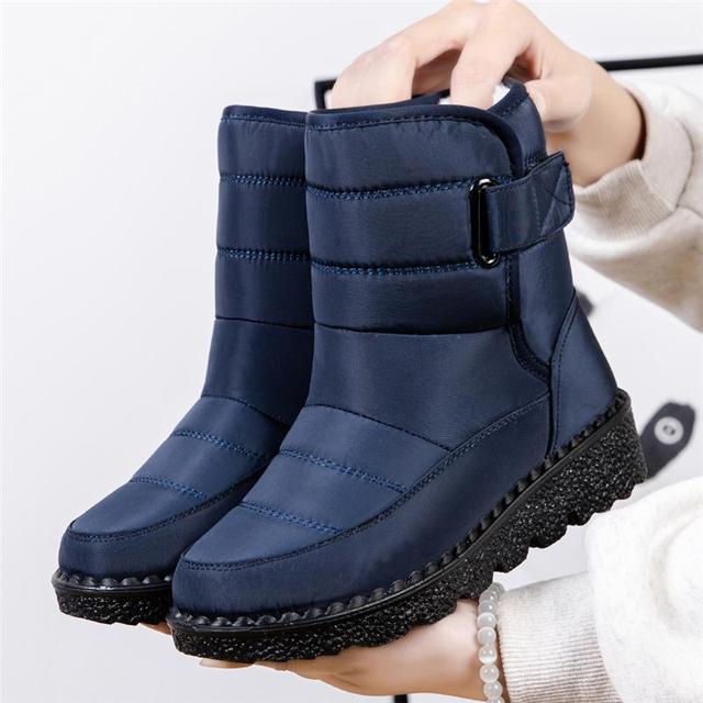 Close-up of women's insulated waterproof winter boots, featuring warm faux fur lining & durable design.