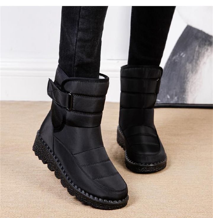 Pair of women's insulated waterproof snow boots, designed for outdoor winter activities & cozy wear.