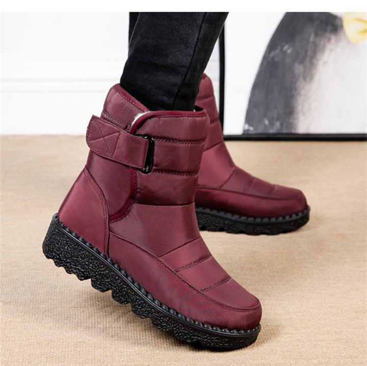 High-top women's waterproof winter boots, offering warm padding, ankle support & non-slip grip for snow.