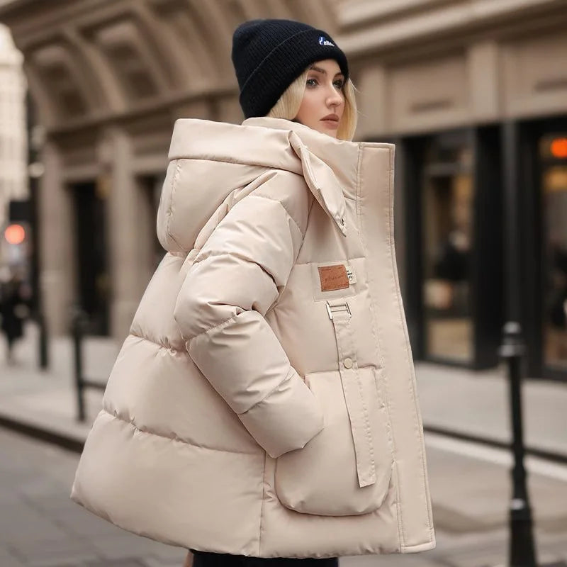 Stylish women's beige winter parka, a cozy hooded jacket perfect for everyday cold weather fashion.