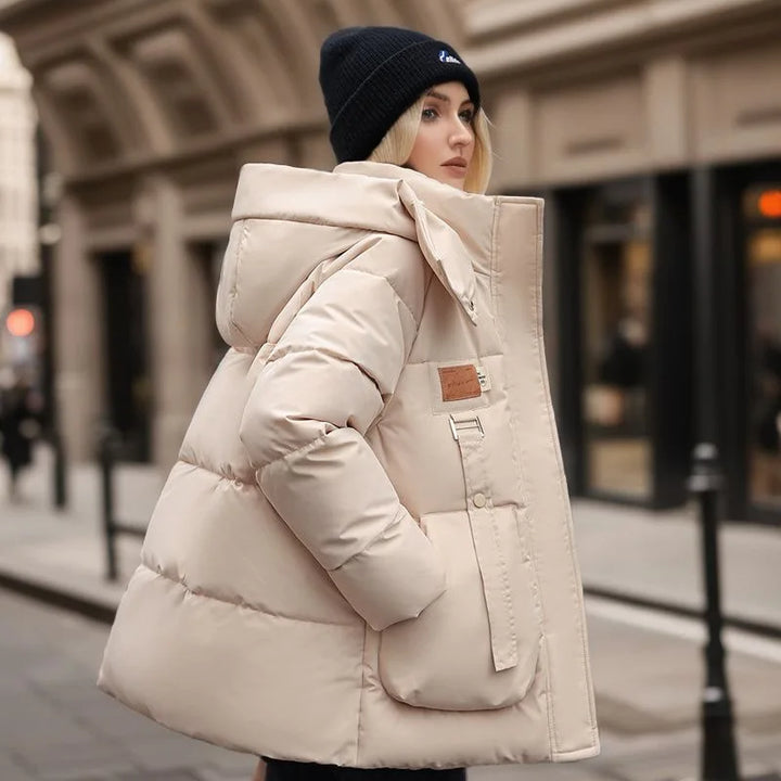 Stylish women's beige winter parka, a cozy hooded jacket perfect for everyday cold weather fashion.